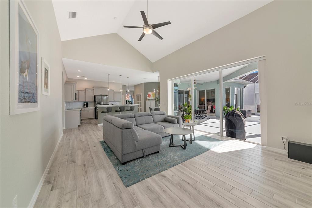 1019 Scherer Way Osprey, FL 34229 - Photo 12 of 56 a living room with furniture kitchen view and a wooden floor