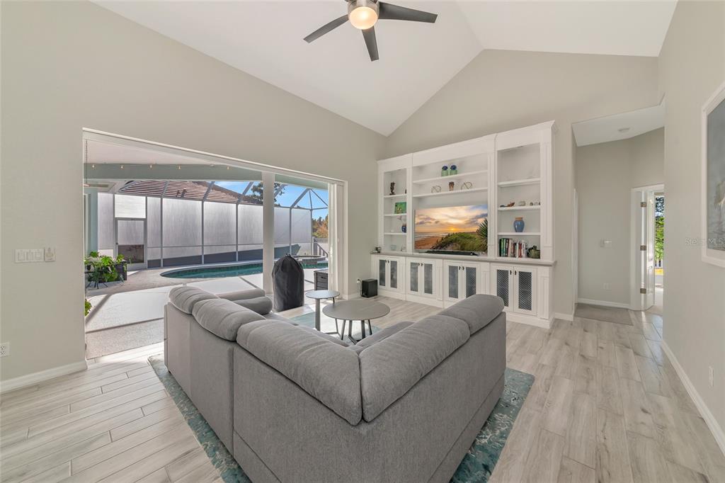 1019 Scherer Way Osprey, FL 34229 - Photo 13 of 56 a living room with furniture and a flat screen tv