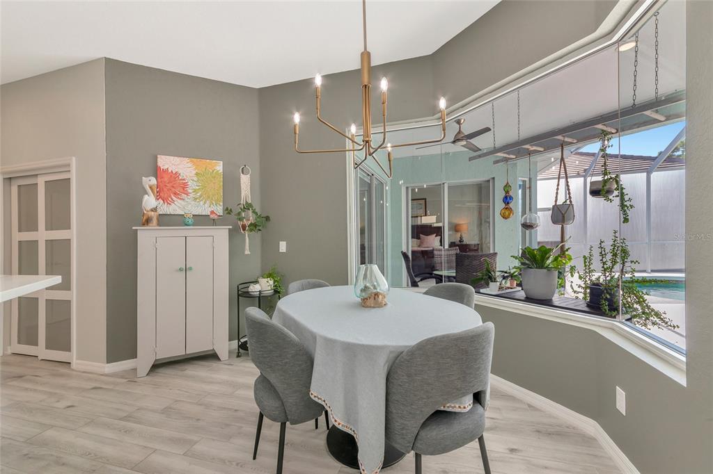 1019 Scherer Way Osprey, FL 34229 - Photo 18 of 56 a dining room with wooden floor and window