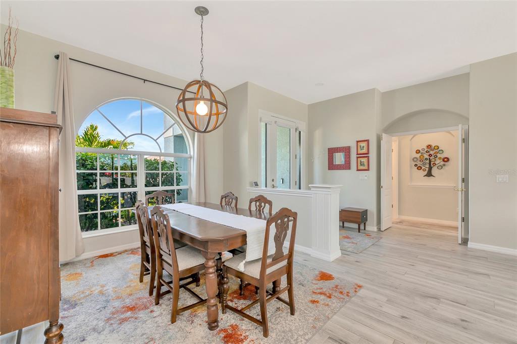 1019 Scherer Way Osprey, FL 34229 - Photo 20 of 56 a view of a dining room with furniture a chandelier and wooden floor