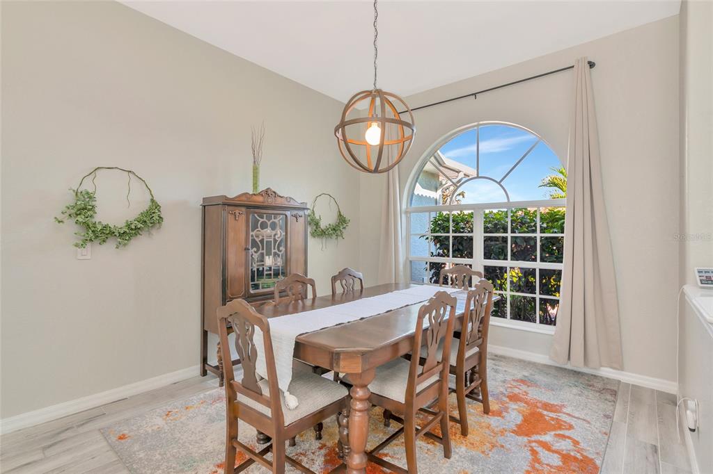 1019 Scherer Way Osprey, FL 34229 - Photo 21 of 56 a view of a dining room with furniture window and wooden floor