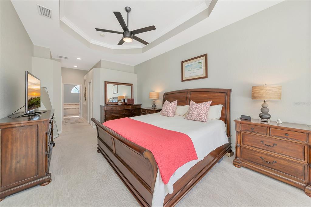 1019 Scherer Way Osprey, FL 34229 - Photo 25 of 56 a bedroom with a bed and a flat screen tv