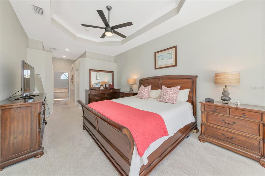 1019 Scherer Way Osprey, FL 34229 - Photo 27 of 56 a bedroom with a bed and a flat screen tv