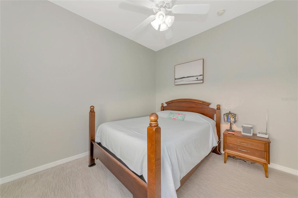 1019 Scherer Way Osprey, FL 34229 - Photo 29 of 56 a bedroom with a bed and a chandelier