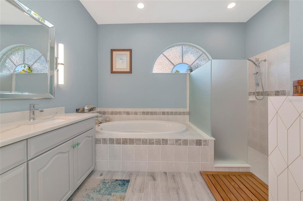 1019 Scherer Way Osprey, FL 34229 - Photo 30 of 56 a spacious bathroom with a double vanity sink and a mirror
