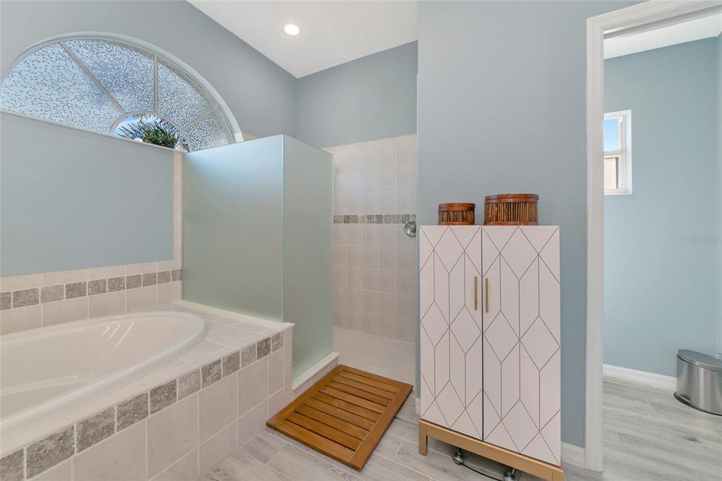 1019 Scherer Way Osprey, FL 34229 - Photo 31 of 56 a bathroom with a tub and shower