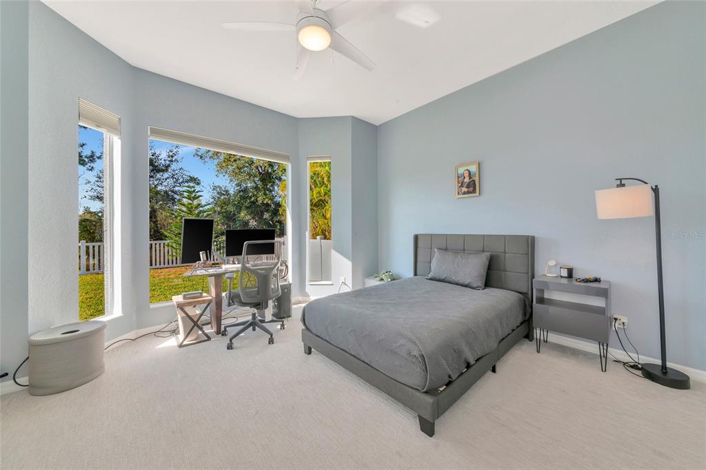 1019 Scherer Way Osprey, FL 34229 - Photo 33 of 56 a bedroom with a bed and a large window