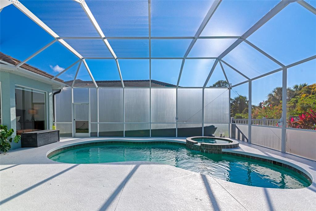 1019 Scherer Way Osprey, FL 34229 - Photo 37 of 56 a view of a patio with a table and chairs under an umbrella