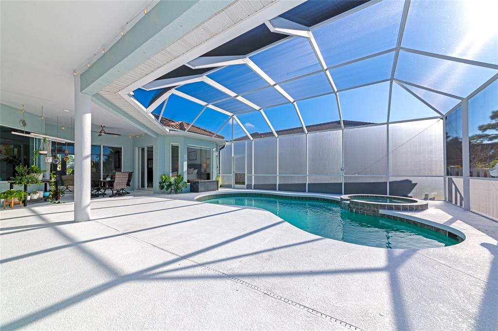 1019 Scherer Way Osprey, FL 34229 - Photo 38 of 56 a view of a patio with a table and chairs under an umbrella