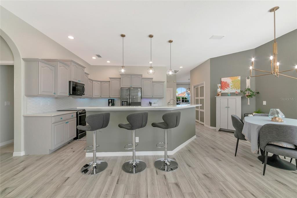 1019 Scherer Way Osprey, FL 34229 - Photo 4 of 56 a large kitchen with a table and chairs