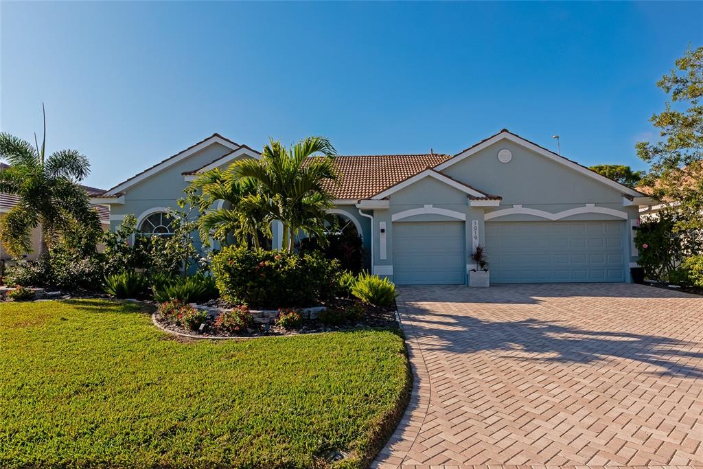 1019 Scherer Way Osprey, FL 34229 - Photo 56 of 56 a front view of a house with a yard