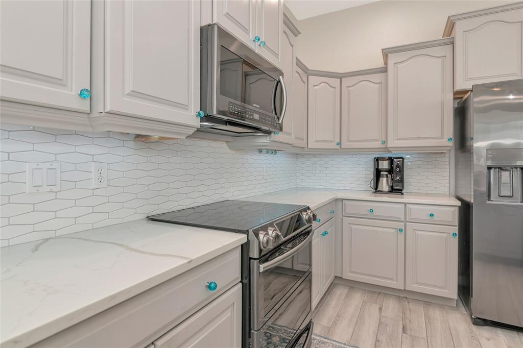 1019 Scherer Way Osprey, FL 34229 - Photo 7 of 56 a kitchen with stainless steel appliances granite countertop a sink a stove and cabinets