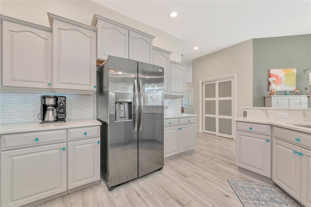 1019 Scherer Way Osprey, FL 34229 - Photo 8 of 56 a kitchen with stainless steel appliances a refrigerator sink and cabinets