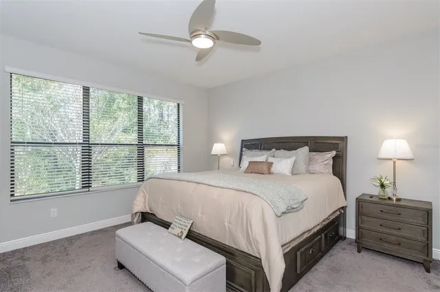 a bedroom with a bed and a lamp