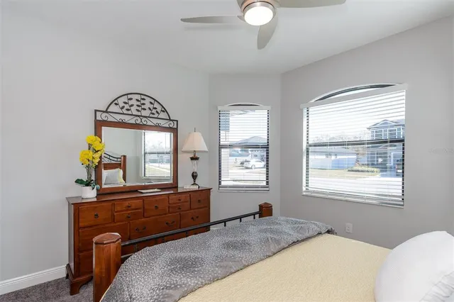 a bedroom with a bed and a dresser in it