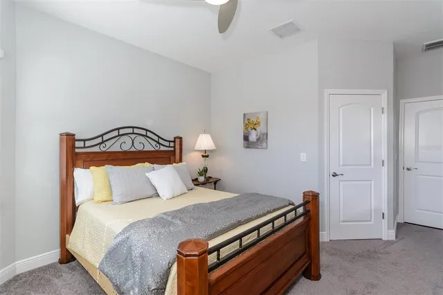 a bedroom with a bed and a dresser in it