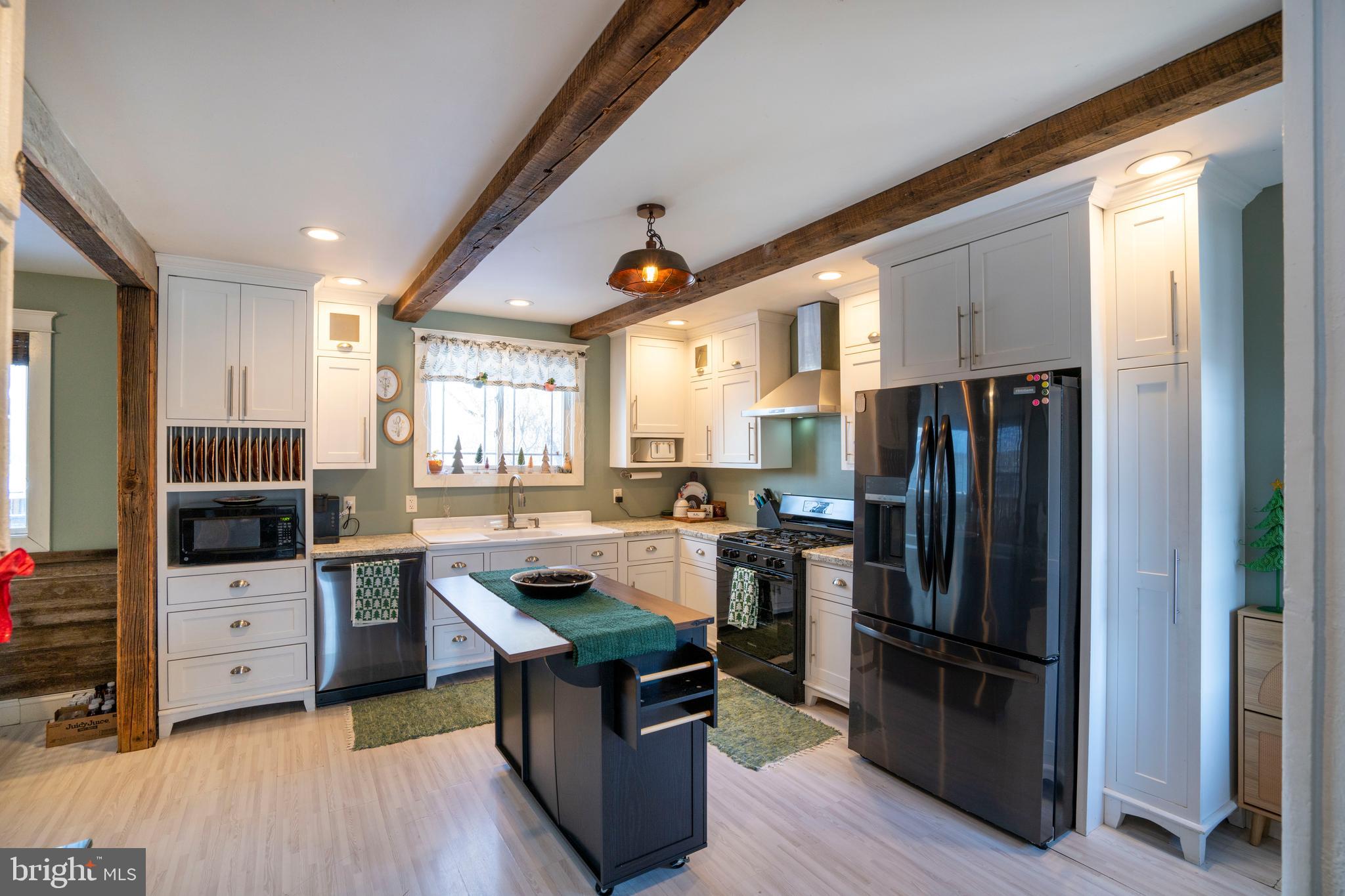 156 East Main Street Howard, PA 16841 - Photo 17 of 84 a kitchen with stainless steel appliances a refrigerator a stove a sink dishwasher and wooden cabinets with wooden floor