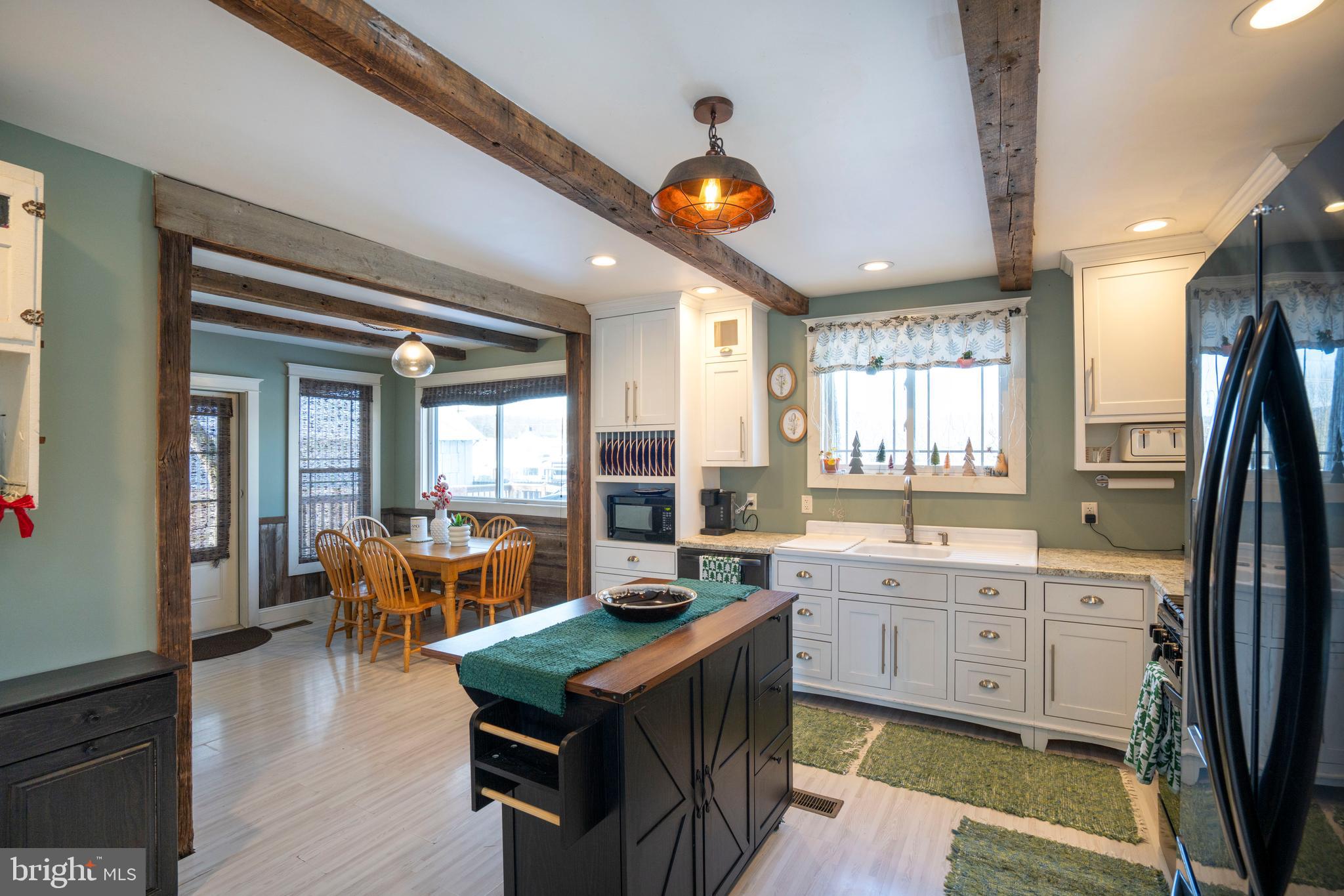 156 East Main Street Howard, PA 16841 - Photo 25 of 84 a large kitchen with kitchen island granite countertop a sink and a large window