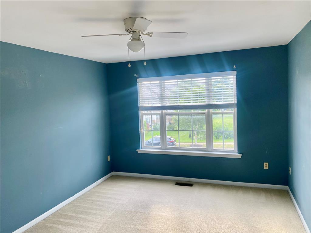 5494 Spring Ridge Drive West Macungie, PA 18062 - Photo 7 of 14 Plentiful natural light streams through a large multi-lite window onto soft carpeting.