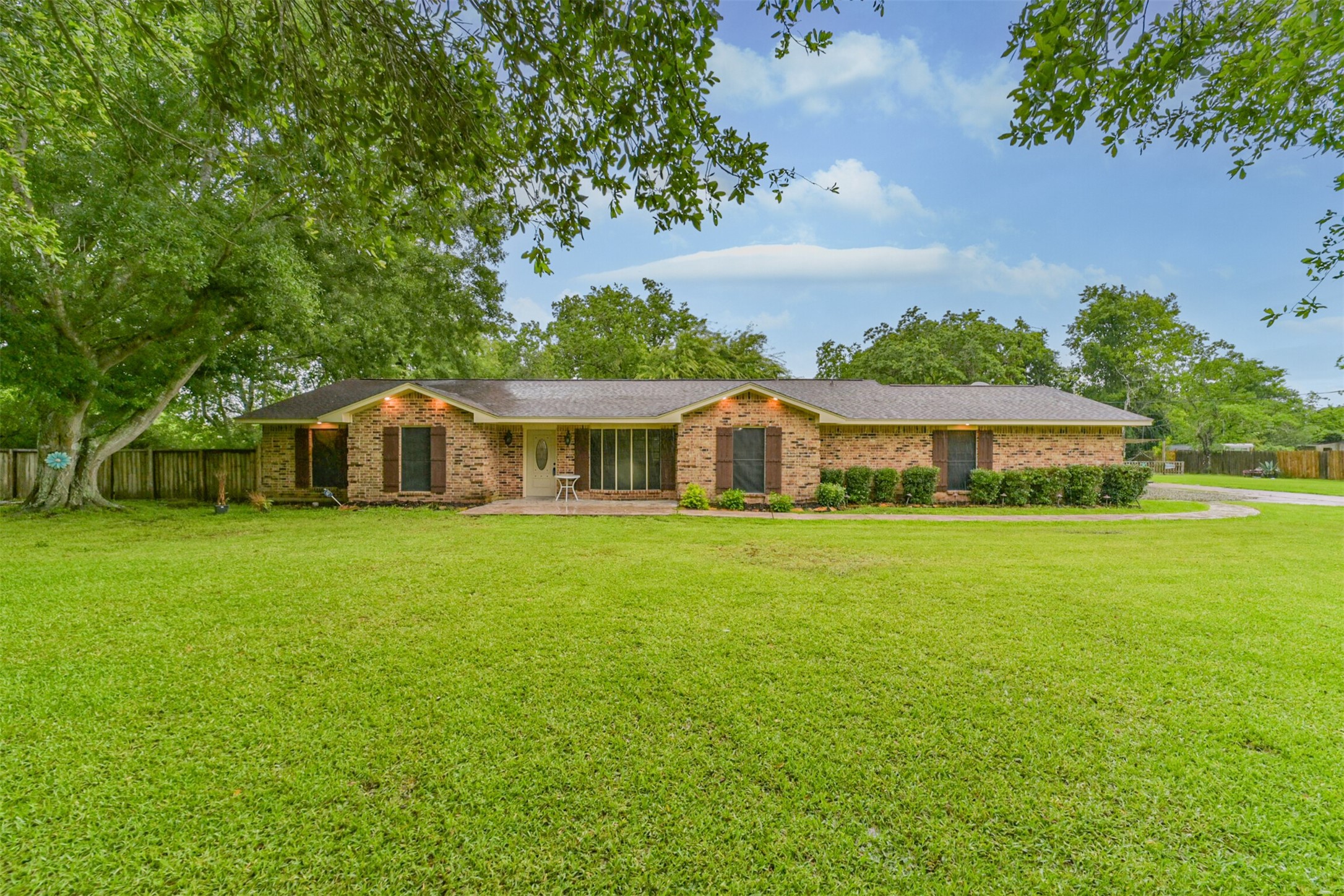 5403 Croix Road Manvel, TX 77578 - Photo 2 of 25 Charming front elevation, extended driveway, gated entry and ranch-style fencing for a peaceful country feel.