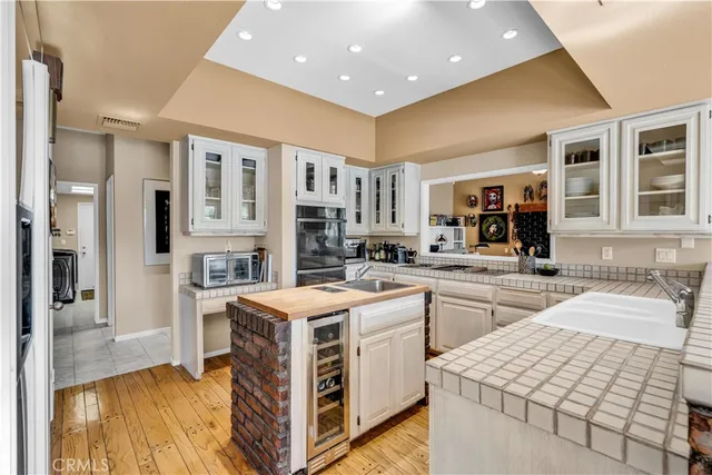 a kitchen with stainless steel appliances kitchen island granite countertop a refrigerator and cabinets