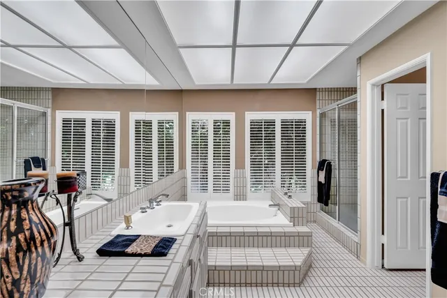 a bedroom with furniture and large windows