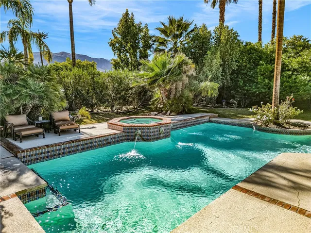 a view of a backyard with swimming pool