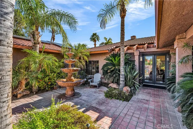 a view of a patio with table and chairs potted plants
