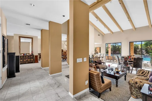 a living room with furniture and large windows