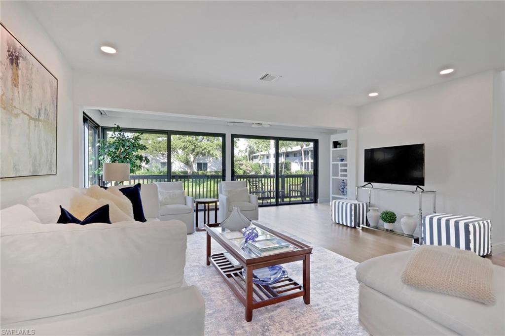 605 8th Avenue South, Unit 605 Naples, FL 34102 - Photo 13 of 50 Living room with wood finished floors, plenty of natural light, and recessed lighting