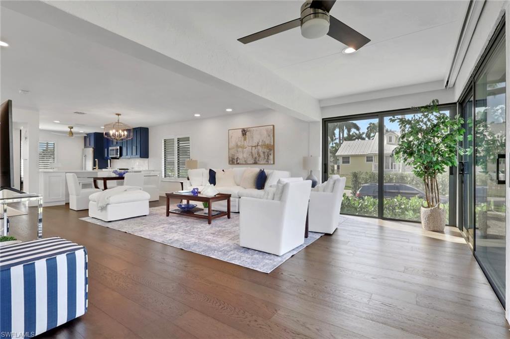 605 8th Avenue South, Unit 605 Naples, FL 34102 - Photo 15 of 50 Living room with a chandelier, healthy amount of natural light, recessed lighting, dark wood finished floors, and a ceiling fan