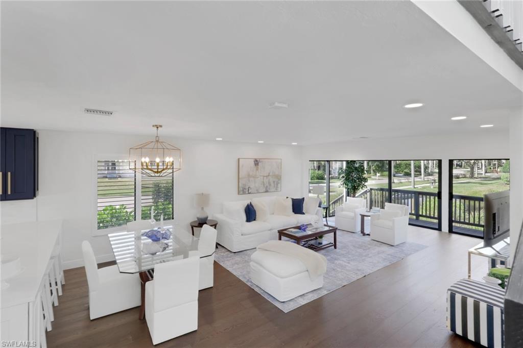 605 8th Avenue South, Unit 605 Naples, FL 34102 - Photo 16 of 50 Living area with dark wood-style floors and a chandelier