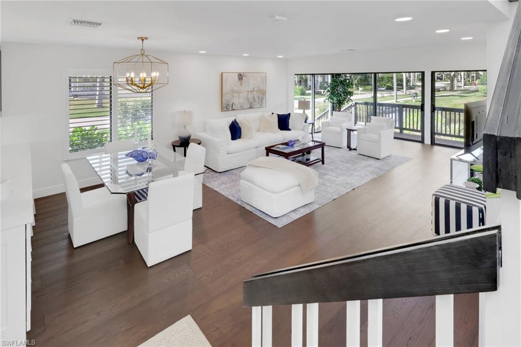 605 8th Avenue South, Unit 605 Naples, FL 34102 - Photo 17 of 50 Living room with dark wood finished floors, a chandelier, and recessed lighting