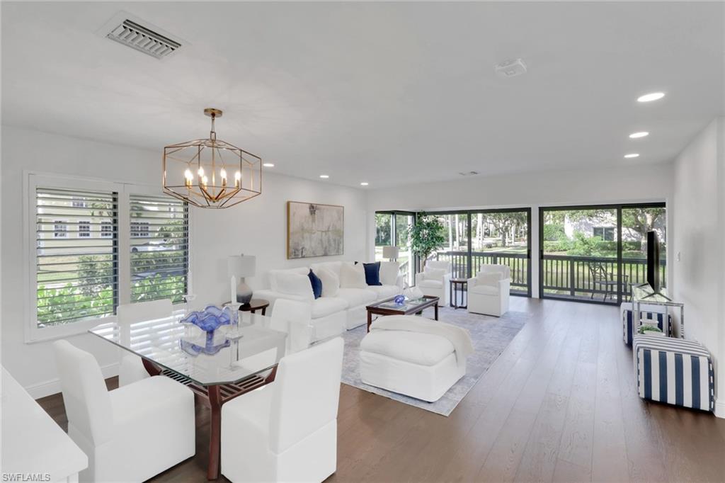 605 8th Avenue South, Unit 605 Naples, FL 34102 - Photo 19 of 50 Dining space featuring dark wood finished floors, healthy amount of natural light, recessed lighting, and a chandelier