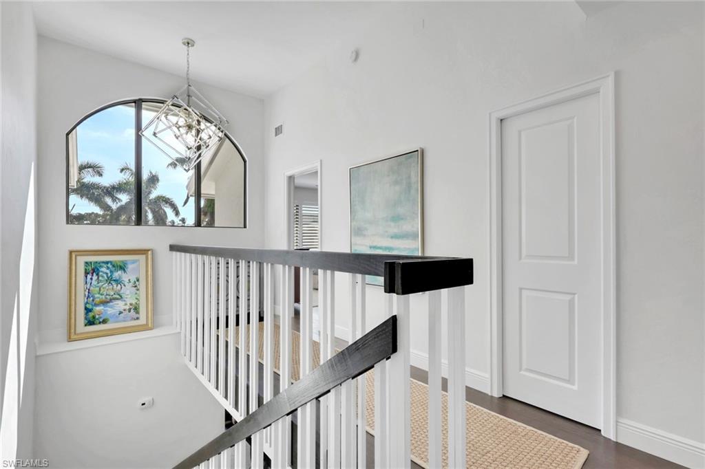 605 8th Avenue South, Unit 605 Naples, FL 34102 - Photo 23 of 50 Hallway featuring an upstairs landing and dark wood finished floors