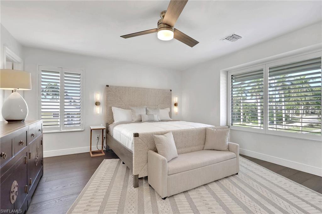 605 8th Avenue South, Unit 605 Naples, FL 34102 - Photo 24 of 50 Bedroom featuring a ceiling fan, multiple windows, and dark wood finished floors