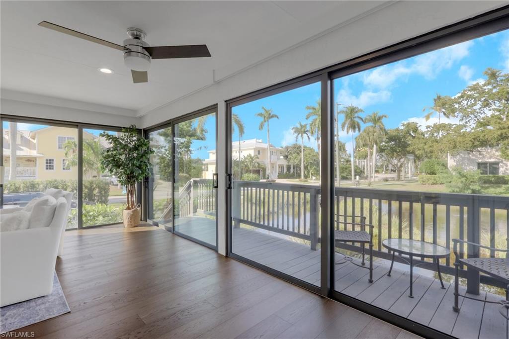 605 8th Avenue South, Unit 605 Naples, FL 34102 - Photo 28 of 50 Sunroom / solarium with hardwood / wood-style flooring, a water view, and recessed lighting