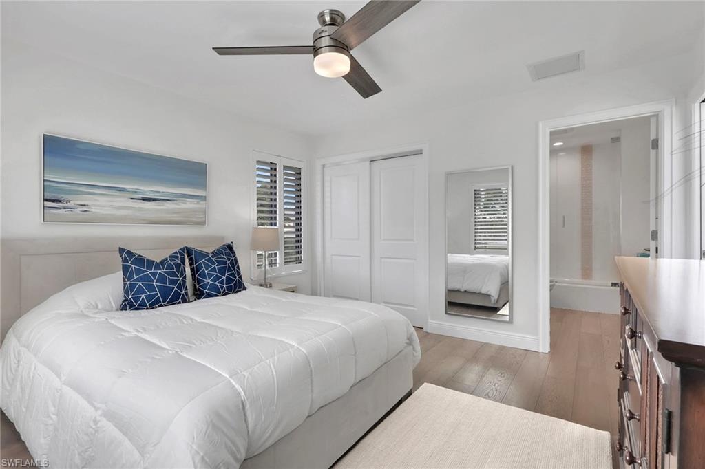 605 8th Avenue South, Unit 605 Naples, FL 34102 - Photo 32 of 50 Bedroom with light wood-type flooring, a closet, and a ceiling fan