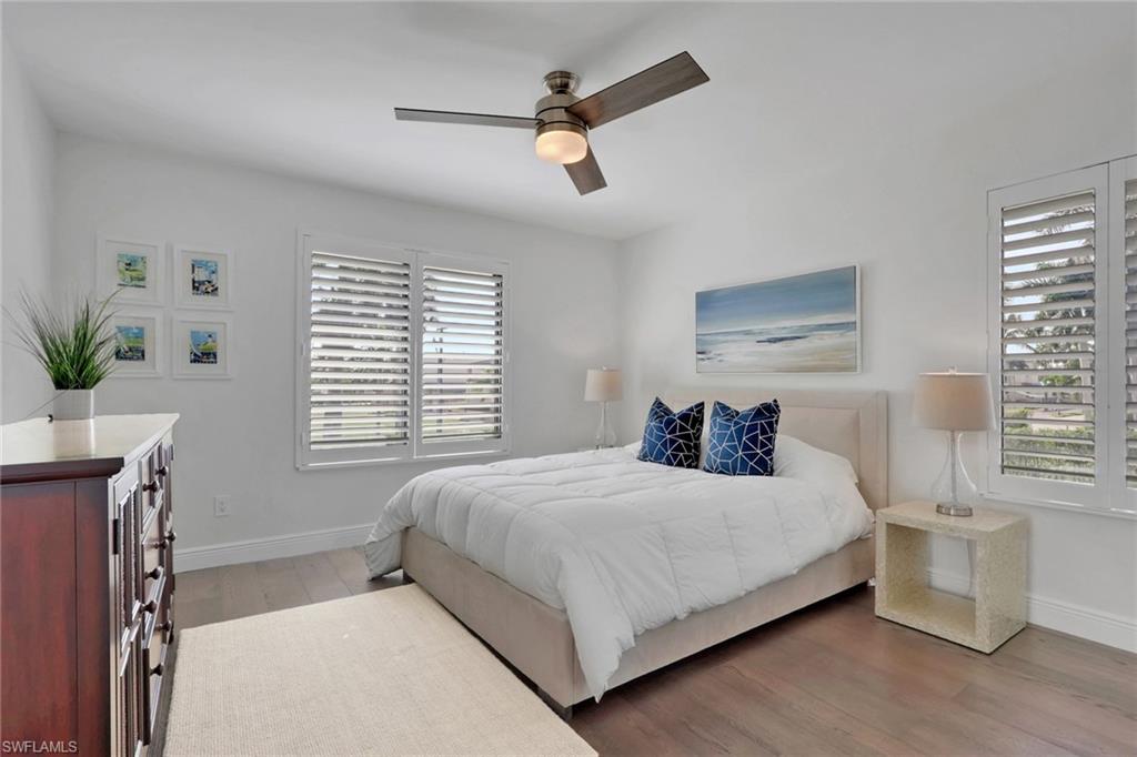 605 8th Avenue South, Unit 605 Naples, FL 34102 - Photo 33 of 50 Bedroom featuring light wood-type flooring and ceiling fan