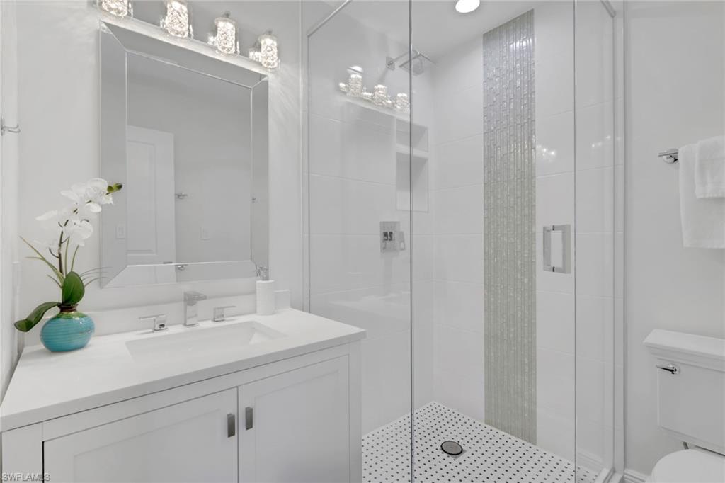 605 8th Avenue South, Unit 605 Naples, FL 34102 - Photo 36 of 50 Full bathroom with a shower stall and vanity