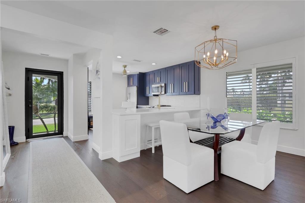605 8th Avenue South, Unit 605 Naples, FL 34102 - Photo 4 of 50 Dining area featuring dark wood-type flooring, a chandelier, and recessed lighting