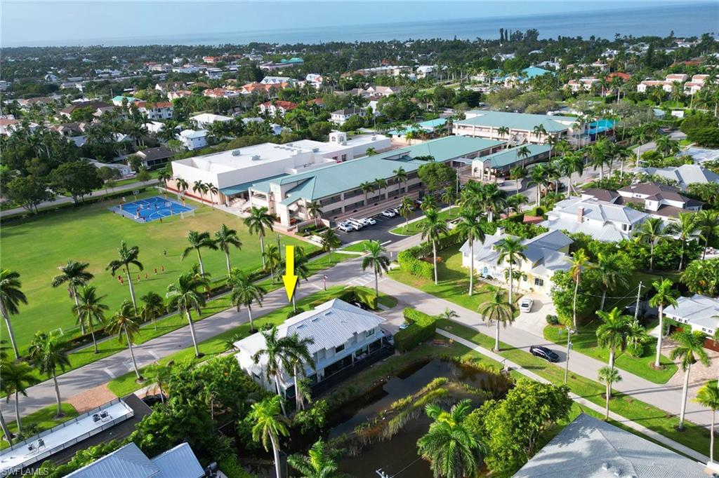 605 8th Avenue South, Unit 605 Naples, FL 34102 - Photo 44 of 50 Aerial view of property and surrounding area featuring a nearby body of water and nearby suburban area