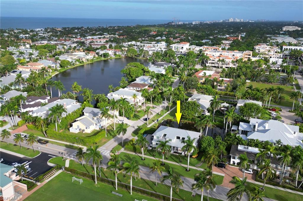 605 8th Avenue South, Unit 605 Naples, FL 34102 - Photo 47 of 50 Aerial view of property and surrounding area with a large body of water and nearby suburban area
