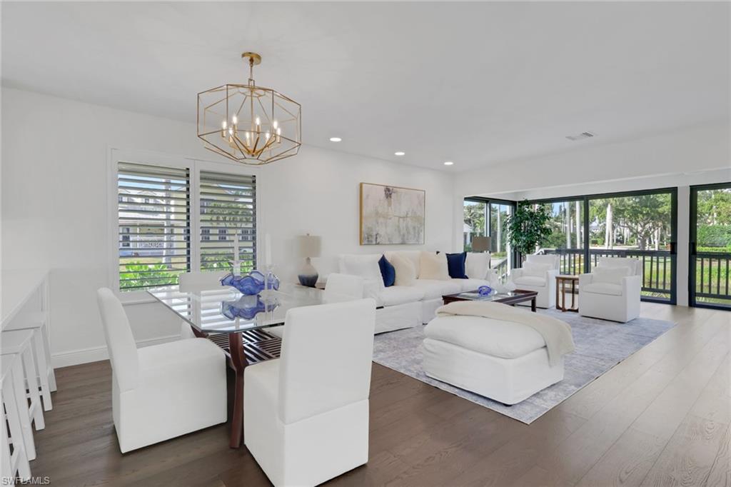 605 8th Avenue South, Unit 605 Naples, FL 34102 - Photo 5 of 50 Dining space with dark wood-type flooring, healthy amount of natural light, recessed lighting, and a chandelier