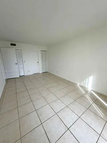 a view of a livingroom with wooden cabinets