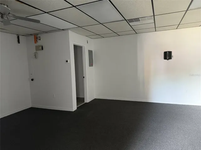 a view of a livingroom with an empty space and a window