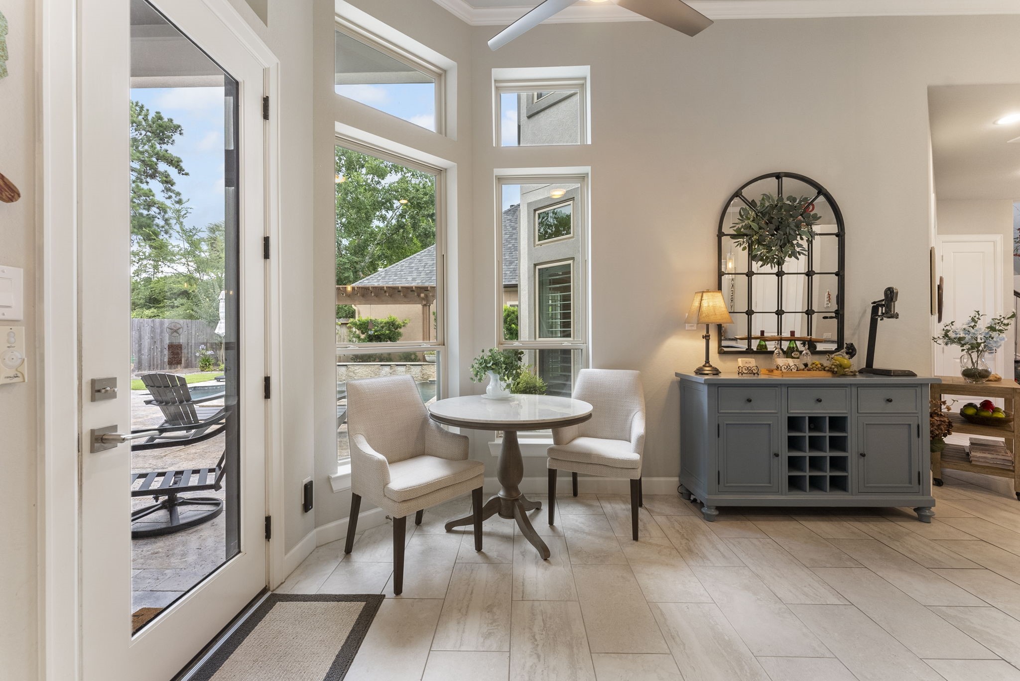 25607 Muirfield Bend Court Spring, TX 77389 - Photo 11 of 30 Sunlit breakfast nook surrounded by walls of windows, offering picturesque views of the pool and outdoor living spaces while creating the perfect setting for casual dining and morning coffee.