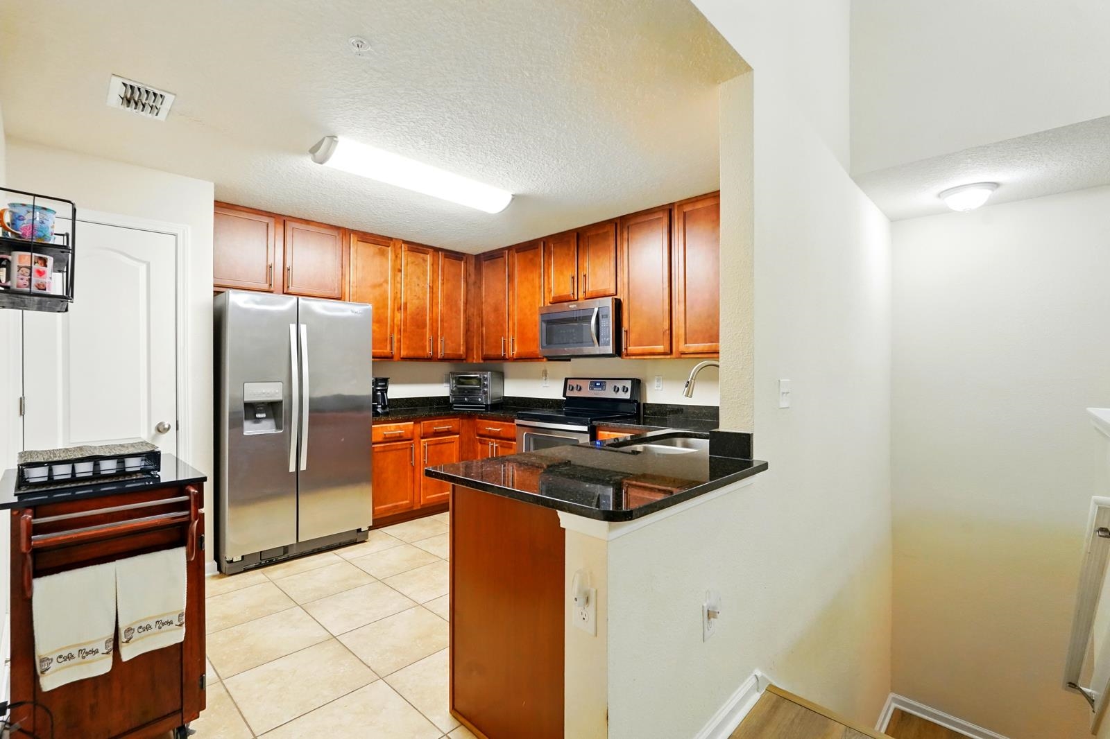 2103 Golden Lake Loop St. Augustine, FL 32084 - Photo 20 of 44 a kitchen with stainless steel appliances granite countertop a refrigerator a stove a sink and a microwave
