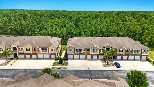 an aerial view of a house with garden space and street view