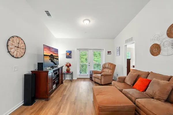 a living room with furniture and wooden floor
